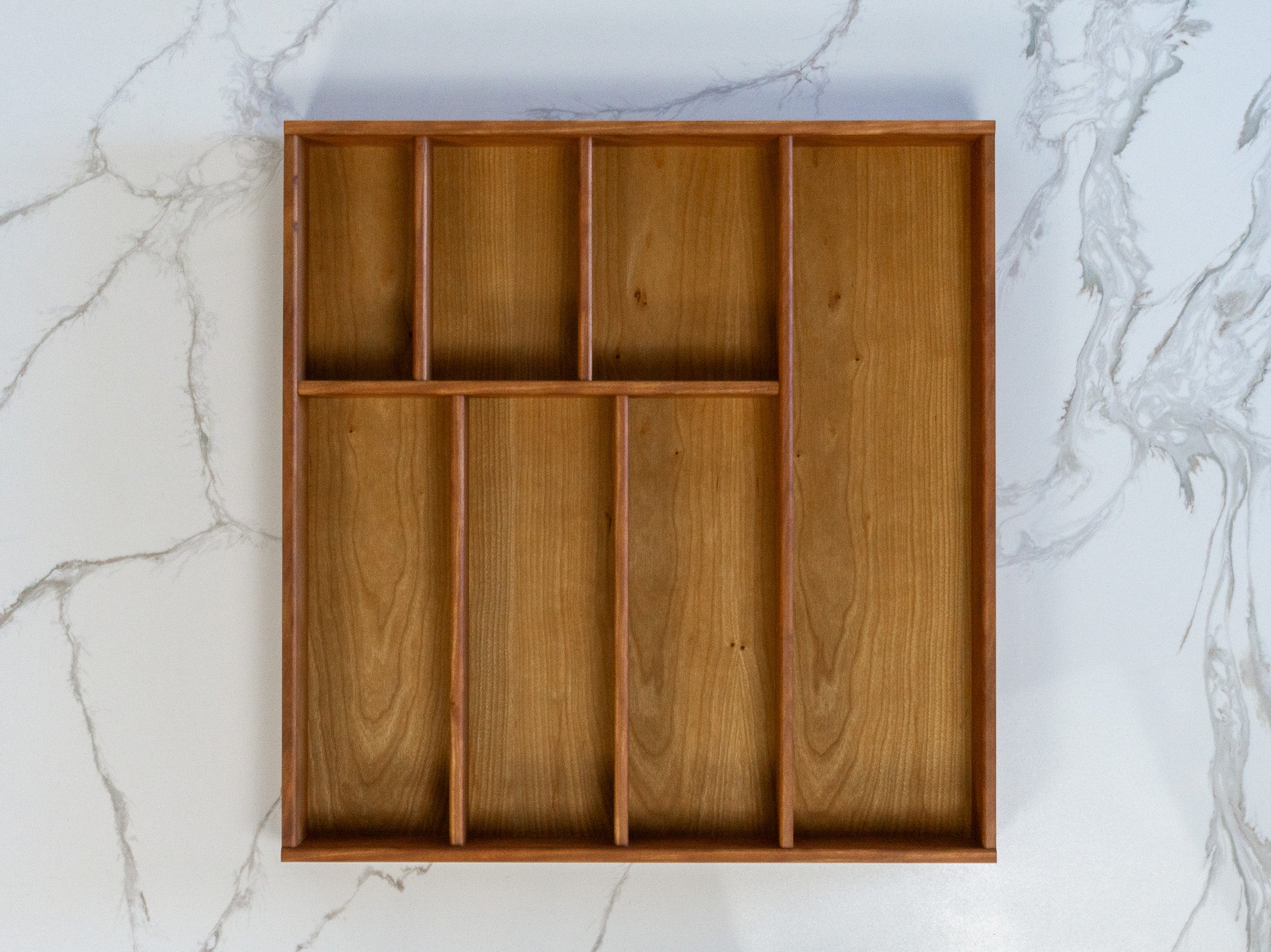 Kitchen drawer organizer in walnut wood, handmade in Arizona, tailored to fit and organize utensils, knives, and gadgets.